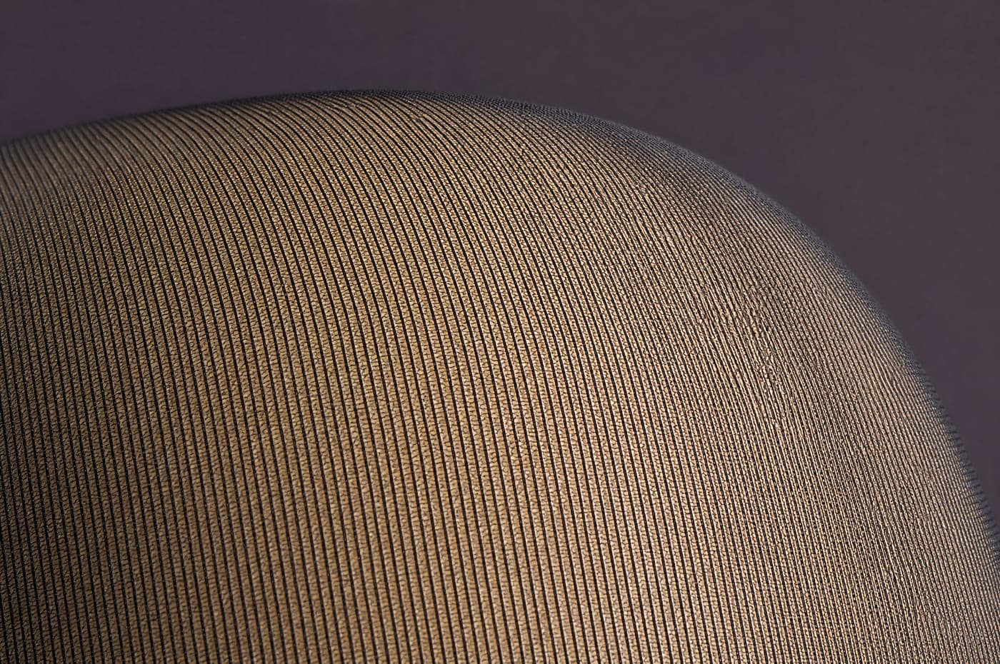 Macro photograph of very fine sheer hosiery, the pale surface reading between individual filaments